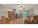 Bright living room with light wood floors, neutral walls, and a sliding glass door to the balcony at 503 Albee Farm Rd # B6, Venice, FL 34285
