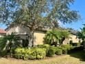 The side of this house is surrounded with palm trees and shrubbery, giving it a tropical feel at 5031 Serata Dr, Bradenton, FL 34211