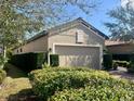 Charming home features a two-car garage, well-manicured shrubs, and a paved driveway at 5031 Serata Dr, Bradenton, FL 34211