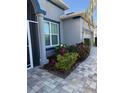 Inviting home entrance featuring a tiled walkway with blue trim and well maintained landscaping at 5414 52Nd W Ave, Bradenton, FL 34210