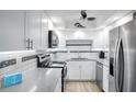 Modern kitchen with stainless steel appliances and white cabinetry at 5855 Midnight Pass Rd # 327, Sarasota, FL 34242
