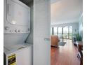 Convenient in-unit laundry featuring a stacked washer and dryer at 5855 Midnight Pass Rd # 327, Sarasota, FL 34242