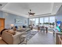Inviting living area with ocean views through large windows, seamlessly blending indoor and outdoor living at 6140 Midnight Pass Rd # 103, Sarasota, FL 34242