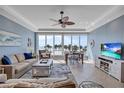 Bright living room featuring floor-to-ceiling windows with stunning beach and ocean views at 6140 Midnight Pass Rd # 103, Sarasota, FL 34242