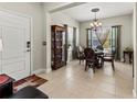 Elegant dining room featuring tile floors, decorative lighting, and ample natural light at 6280 Cassia St, Bradenton, FL 34203