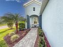 Charming covered front porch with stone walkway and comfortable seating area at 6280 Cassia St, Bradenton, FL 34203