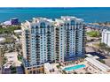Upscale high-rise condo shows exterior balconies, pool area, and stunning water views of the bay at 800 N Tamiami Trl # 312, Sarasota, FL 34236