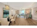 Open living space with dining area, balcony access and attractive contemporary decor at 800 N Tamiami Trl # 312, Sarasota, FL 34236