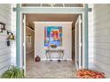 Elegant foyer with tiled floors, colorful artwork, and a glimpse into the home's open and inviting layout at 8012 18Th W Ave, Bradenton, FL 34209
