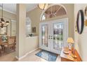 Beautiful front entryway featuring a tiled floor, double doors with glass inserts, and sidelight windows at 854 Dahoon Cir, Venice, FL 34293