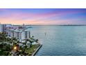 Elevated view of a waterfront condo, showcasing a pool and the building's proximity to the water at 97 Sunset Dr # 202, Sarasota, FL 34236