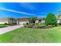 Charming home featuring lush landscaping, a brick driveway, and a well-maintained lawn at 12263 Lavender Loop, Bradenton, FL 34212