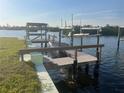 Dock featuring boat lift, providing direct access to the canal at 1230 S Maryknoll Rd, Englewood, FL 34223