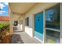 Condo's exterior hallway showing a blue front door with unit number 102 at 1600 1St W Ave # 102A, Bradenton, FL 34205