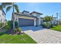 Attractive home features a well-kept lawn, a paver driveway, and lush landscaping at 16816 Seraphic Trl, Lakewood Ranch, FL 34211