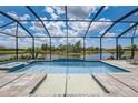 Sparkling screened-in pool and spa with a beautiful lake view, perfect for relaxation and entertainment at 19912 Bridgetown Loop, Venice, FL 34293
