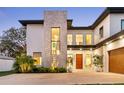 Stunning modern home showcasing clean lines, stone facade, and manicured landscaping at 2177 Sunnyside Pl, Sarasota, FL 34239