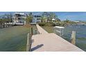 Private dock with weathered wood planks along the channel with a ladder and cleaning station at 2407 Avenue A, Bradenton Beach, FL 34217