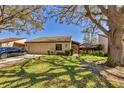 Inviting home with mature tree, lush green lawn, and two-car garage providing ample parking and curb appeal at 3722 Glen Oaks Manor Dr, Sarasota, FL 34232