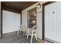 Front entryway with covered porch, white door, and neutral-toned seating area at 3758 59Th W Ave # 4099, Bradenton, FL 34210