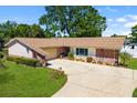 Aerial view of a charming home with a brick facade, lovely landscaping, and a large driveway at 3802 24Th W Ave, Bradenton, FL 34205