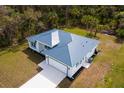 Aerial view of a well-designed single-story home with an attached garage and landscaped surroundings at 3807 Las Vegas Ave, North Port, FL 34288
