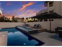 Relaxing outdoor swimming pool area with lounge chairs and a stylish umbrella providing shade by the luxurious home at 3916 N Shell Rd, Sarasota, FL 34242