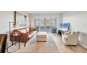 Bright living room featuring a comfortable brown leather sofa and sliding doors to the lanai at 404 Cerromar N Cir # 119, Venice, FL 34293