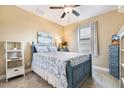 Charming bedroom with blue accents, tile flooring, and a bright window at 4386 Library St, Port Charlotte, FL 33948