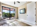Bright living room featuring patio access, a ceiling fan, and tiled floors at 4386 Library St, Port Charlotte, FL 33948