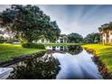 Scenic view of pond reflecting the surrounding lush landscape and community buildings at 4425 45Th W Ave # 101, Bradenton, FL 34210