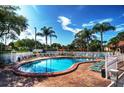 Outdoor pool featuring an expansive deck with ample seating and tropical landscaping at 4425 45Th W Ave # 101, Bradenton, FL 34210