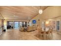 Bright living room with tile floors, vaulted ceilings, fireplace, and beautiful water views at 4535 Bay Club Dr, Bradenton, FL 34210