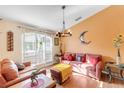 Bright living room featuring hardwood floors, stylish furnishings, and shuttered windows at 4845 Wilde Pointe Dr, Sarasota, FL 34233