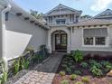 Inviting front entrance with a brick walkway, manicured landscaping, and double doors, creating a welcoming first impression at 5103 Windward Ave, Sarasota, FL 34242