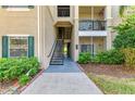 Exterior entrance to condo shows stairs to the second floor, enhanced by nice landscaping around the front at 5160 Northridge Rd # 302, Sarasota, FL 34238