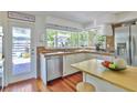 Bright kitchen with stainless steel appliances, natural light, and a door to the outside patio at 5221 Stevens Dr, Sarasota, FL 34234