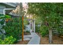 A beautiful landscaped walkway featuring lush greenery and a charming pergola entrance at 5221 Stevens Dr, Sarasota, FL 34234