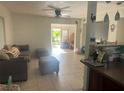 Inviting living room features tile flooring and an open floor plan leading to another room at 540 Palmetto Ne Dr, Port Charlotte, FL 33952