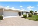 Home exterior showcasing well-maintained landscaping, an attached garage, and welcoming front entrance at 6902 8Th W Ave, Bradenton, FL 34209