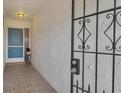 View of front door entrance with tiled floors, secured with a decorative iron security gate at 7402 8Th W Ave, Bradenton, FL 34209