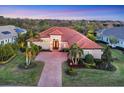 Aerial view of a house with lush green landscaping and trees surrounding the perimeter at 7469 Seacroft Cv, Lakewood Ranch, FL 34202