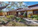 Inviting single-story home with mature trees and lush greenery enhancing its curb appeal at 7523 4Th W Ave # 7523, Bradenton, FL 34209