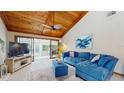 Bright living room with vaulted wood ceiling, sliding glass doors, and comfortable seating at 7523 4Th W Ave # 7523, Bradenton, FL 34209