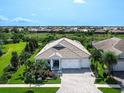Expansive aerial view of a home showcasing its well-manicured lawn and a serene neighborhood at 813 Tailwind Pl, Sarasota, FL 34240