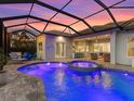 Tranquil pool and patio area, perfect for evening relaxation with its ambient lighting and comfortable seating at 813 Tailwind Pl, Sarasota, FL 34240