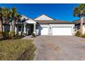 A well-kept home with beautiful curb appeal, featuring a two-car garage and lush landscaping at 922 Fernleaf Run, Bradenton, FL 34212