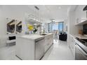 Modern kitchen featuring a large island with stainless steel appliances and an open concept design at 111 S Pineapple Ave # 918, Sarasota, FL 34236