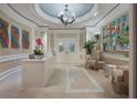 Inviting lobby with elegant chandelier, marble floors, contemporary artwork, and reception desk at 1111 Ritz Carlton Dr # 1704, Sarasota, FL 34236