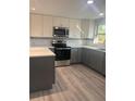 This kitchen boasts modern stainless steel appliances, dual-tone cabinets, and sleek countertops at 2020 45Th Street Ct E # A, Bradenton, FL 34208